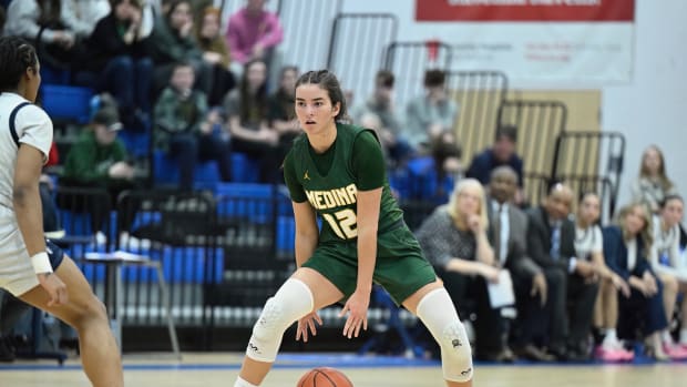 Medina's Olivia Klanac dribbles through her legs and she surveys the defense in a district final game against Archbishop Hoban on March 1, 2024.